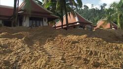 Digger and sunbathers on Khao Lak beach News Clip