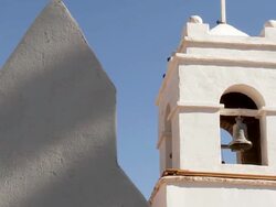 CU PAN Shot of White church wall to bell tower / San Pedro de Atacama, Norte Grande, Chile Stock Footage