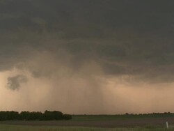 WS View of swirling clouds and raining over green prairie / Hillsboro, Texas, United States Stock Footage