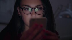 Phone scrutiny, glasses reflections.  Young woman close up. Stock Footage