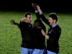 SLO MO TU professional soccer player being lifted on to shoulders of teammates in celebration on field Stock Footage