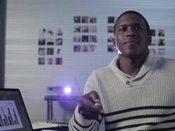 Young man in creative space using laser pointer during slide show Stock Footage