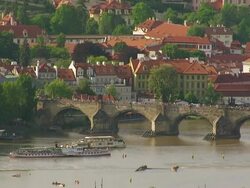 WS AERIAL View of pedestrian crossing bridge and ferry passing down bridge / Prague, Czech Republic Stock Footage