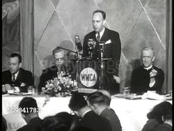 1946: HOUSING MEETING: Wilson Wyatt standing behind WMCA podium speaking about housing shortage, '...must be done...will be done.' audience applauding. Instructional Video