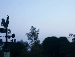 Weathervane moves in the wind at sun rise Stock Footage