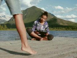 Boom shot of pre-teen girls look at digital tablet, in mtns Stock Footage