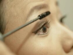 woman applying mascara on her eyelash Stock Footage