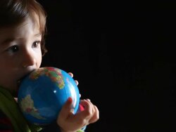 Little boy playing with globe Stock Footage