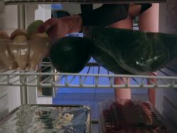 Woman puts cakes into the fridge and takes strawberry Stock Footage