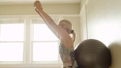 A mature woman lifts weights in her home gym. Stock Footage