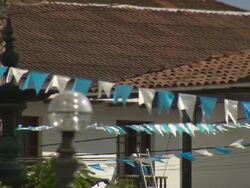 "CU of blue and white bunting blowing in the wind, Plaza De La Armas, Chachapoyas, Peru [PerÃƒÂº]" Stock Footage