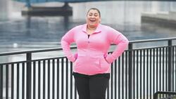 Heavy Hispanic woman exercising, jogging on waterfront Stock Footage
