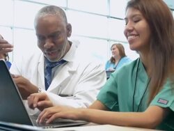Professor encouraging nursing or medical student in college classroom Stock Footage