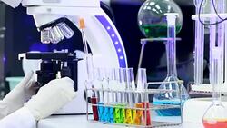 Scientist using microscope and looking a sample Stock Footage