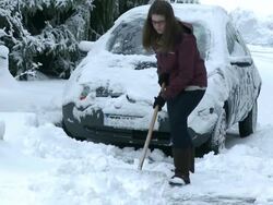 MS Woman removing snow from street / Saarburg, Rhineland-Palatinate, Germany Stock Footage