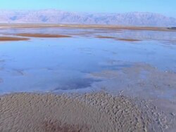 Aerial the Dead Sea in the Judea Desert, low track forward over shallows, Israel Stock Footage