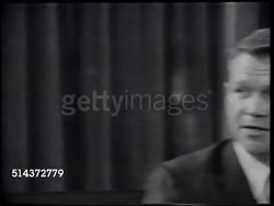 1966: JOHN SWAINSON: VS John talking w/ others at Cocktail Party in his home, MS (Behind brunette) John's wife asking Marilyn if she wants another drink, [VO John wants to continue working for the people.] Instructional Video