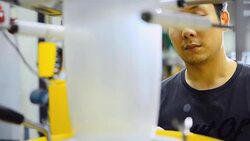 panning: young engineer consider blown film operations Stock Footage