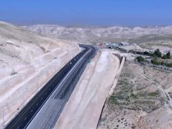 Aerial Highway 1 connecting Jerusalem and the West Bank until the Beit HaArava Junction with Route 90 south of Jericho near the shores of the Dead Sea, Northern Judea Desert Stock Footage