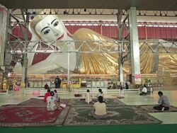 WS View of People praying to huge Buddha statue inside temple / Yangon, Yangon Division, Myanmar  Stock Footage