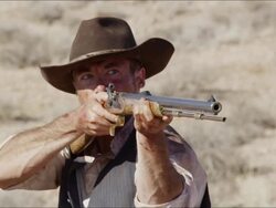 Slow motion of cowboy lifting his rifle to shoulder and aiming gun. Stock Footage