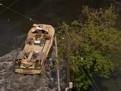 Aerial zoom out amphibious military vehicles in flooded Gentilly subdivision / New Orleans, Louisiana Stock Footage