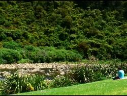 Young Woman Sitting and Thinking By River Stock Footage