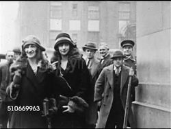 1921: COLORFUL WOMEN: VS American actress Peggy Hopkins Joyce on deck of ocean liner dressed in cloche hat & fur coat.  VS British actress 'the Countess of Cathcart' standing w/ female friend outside building in New York, people watching BG. Instructional Video