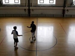 WS Two young men playing basketball against each-other inside  gymnasium / Minneapolis, Minnesota, United States  Stock Footage