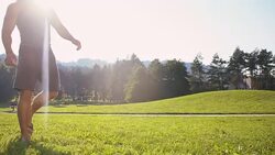 SLO MO Young man training his dog catching a ball Stock Footage