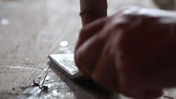 Hammer pulling nail from wood Stock Footage