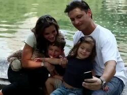 MS Family rests father taking photo of himself and family at  small sailboat pond / New York, New York, United States   Stock Footage
