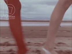 Fashion Collection Spring-Summer 1971 - Semi nude lingerie models on beach, women catwalking on beach modelling tights only Stock Footage