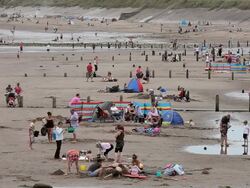 HOLIDAY MAKERS ON BEACH Stock Footage