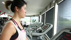 sport women running on treadmill cardio equipment Stock Footage