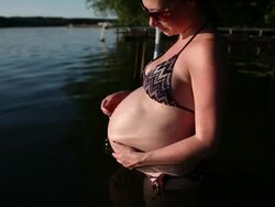 Pregnant woman in lake Stock Footage