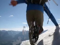 Mountaineer jumps overhead camera Stock Footage