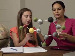 Daughter Shows Mother her Science Project of a Molecule Stock Footage