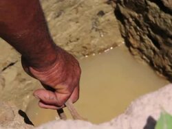 CU Shot of Men collecting water from shafts / Pilao Arcado, Bahia, Brazil Stock Footage
