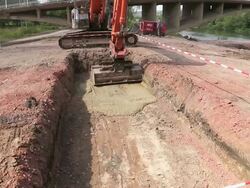 MS Shot of excavator leveling material in pit at bridge construction site at Saar river, Wiltingen, Germany / Wiltingen, Rhineland Palatinate, Germany Stock Footage