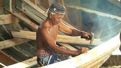 Asian elderly carpenter making wooden boat. Stock Footage