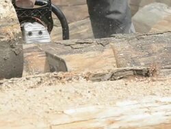 Cutting log with a chainsaw Stock Footage