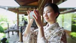 Smiling Woman Taking Photograph at Shrine Stock Footage