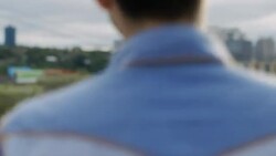 Young woman dances and laughs with boyfriend on rooftop overlooking downtown Austin, Texas Stock Footage