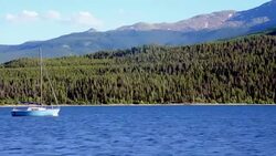 Boat Anchored Down in the Middle of Twin Lakes Mountain Vista on the water Stock Footage