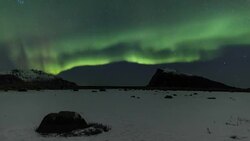 Northern Lights over the frozen Arctic fjord - solar storm Stock Footage