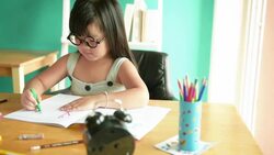 cute girl drawing with colourful pencils,Young girl painting on Coloring book. Stock Footage