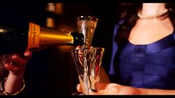 Champagne being poured woman in background Stock Footage