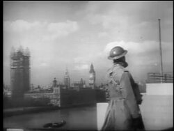 B/W 1940 British soldier looking for German planes in sky / Parliament building in background / London Stock Footage