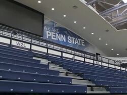 Shot of the "We are Penn State" sign in the Bryce Jordan Center at Pennsylvania State University. The shot pulls out revealing the seating Stock Footage